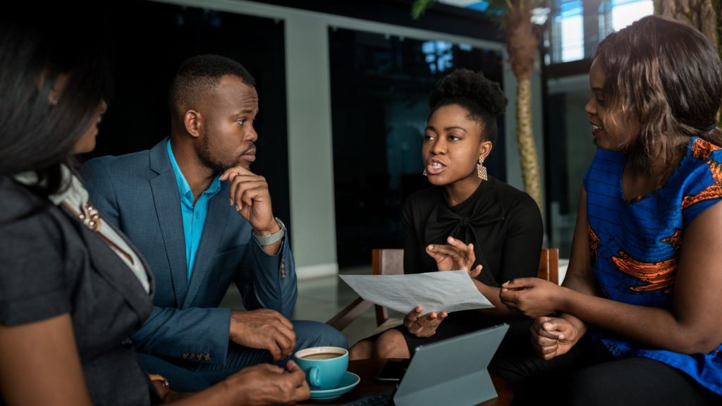 African professionals discussing diaspora wealth